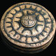 A star-ornamented belt box found in the assemblage.